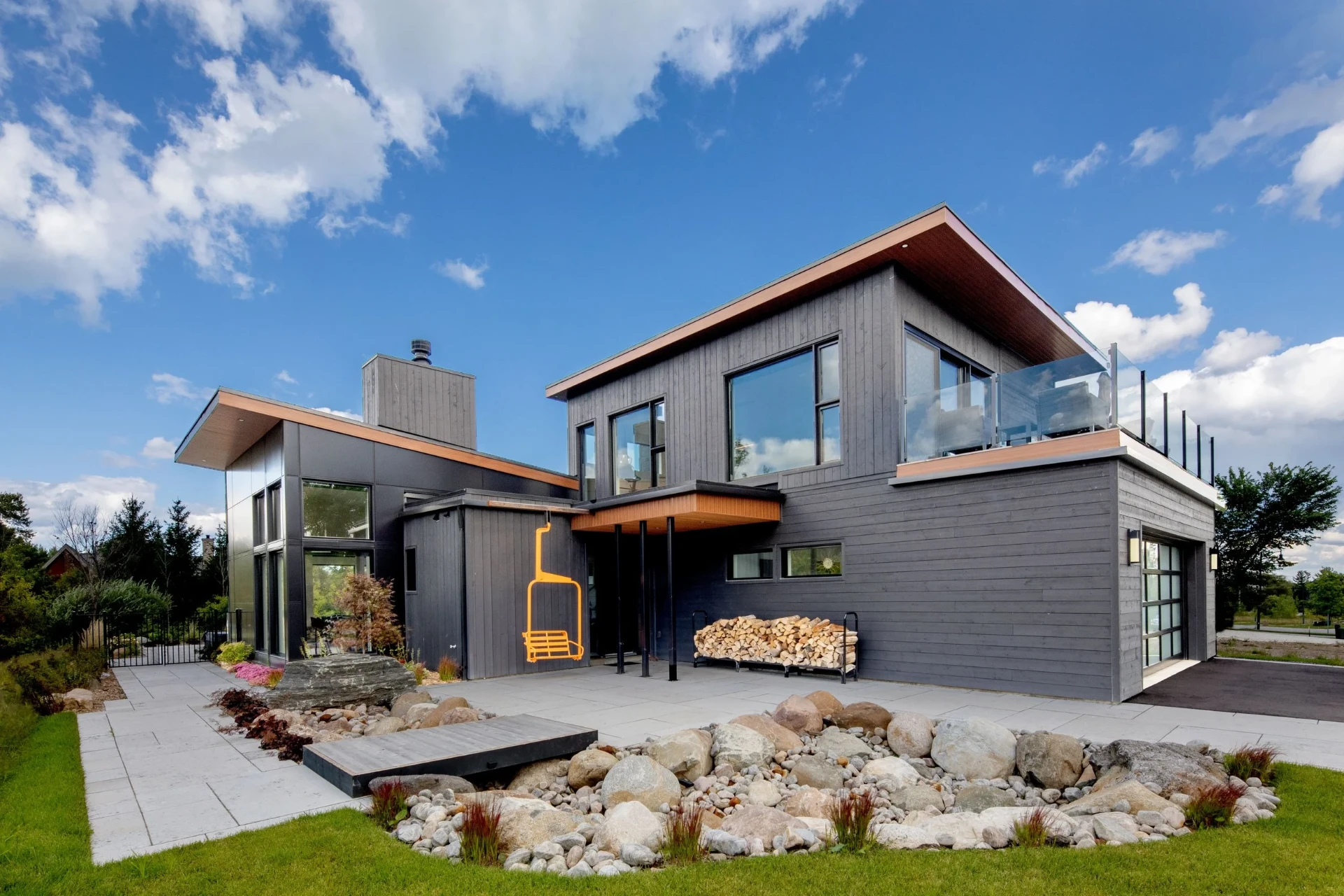 Modern two-story building with glass balcony and landscaped grounds completed by JMS Contractors